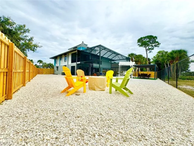 View of play area featuring glass enclosure and a fenced backyard