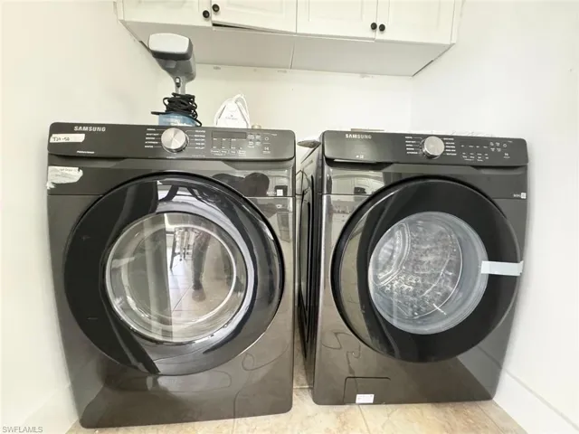 Laundry room featuring cabinet space and washing machine and dryer