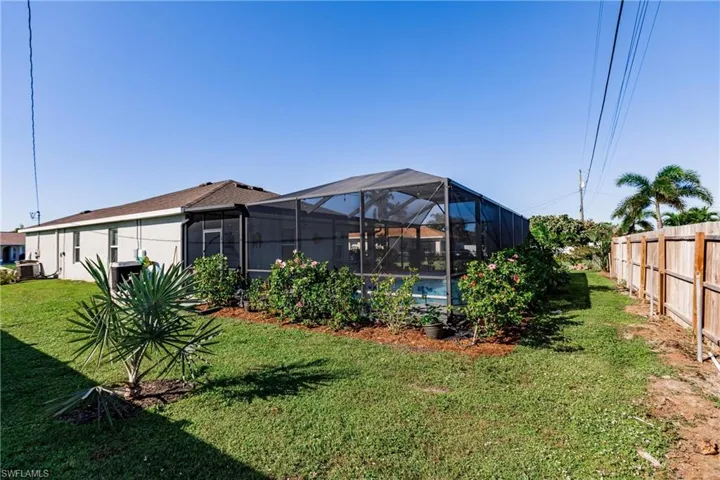 View of yard featuring glass enclosure