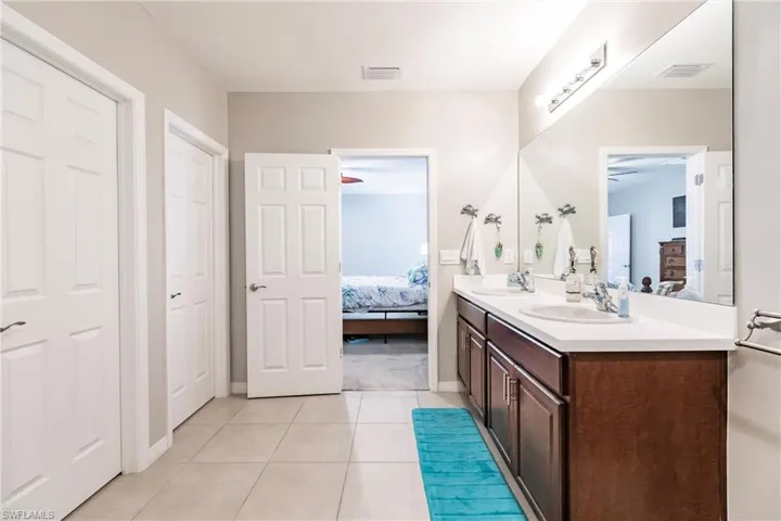 Bathroom featuring tile patterned flooring, ceiling fan, and vanity