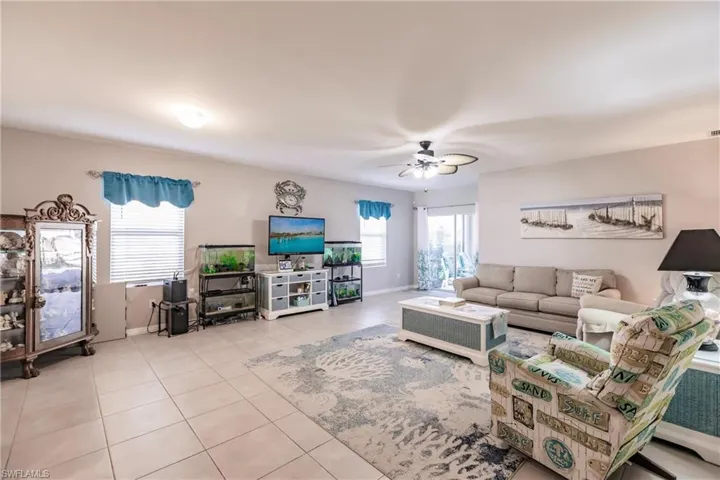 Tiled living room featuring ceiling fan