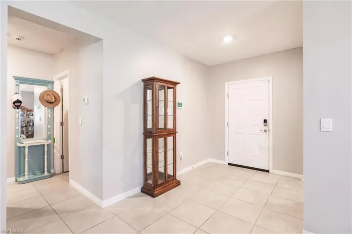 Foyer entrance featuring light tile patterned flooring