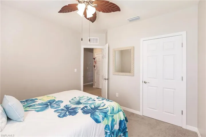 Bedroom featuring ceiling fan and light carpet