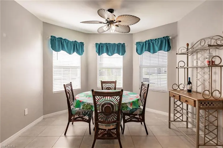 Tiled dining room with ceiling fan