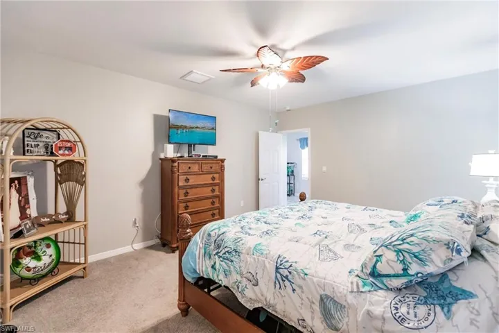 Bedroom featuring ceiling fan and light colored carpet