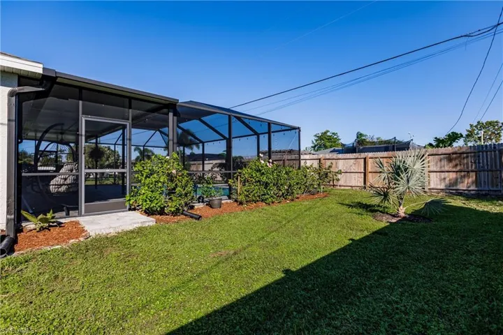 View of yard featuring glass enclosure