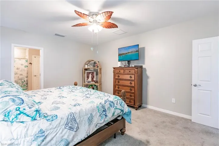 Bedroom with light carpet and ceiling fan