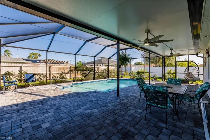 View of pool with a lanai and a oversized covered patio