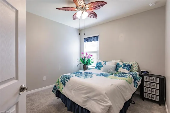 Bedroom featuring ceiling fan and light carpet