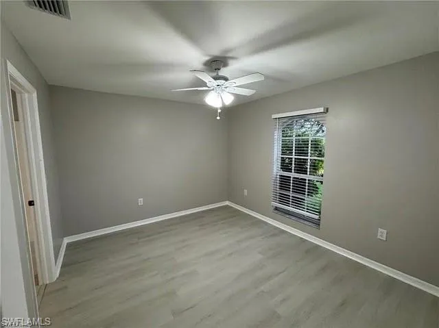 Spare room with ceiling fan and wood finished floors