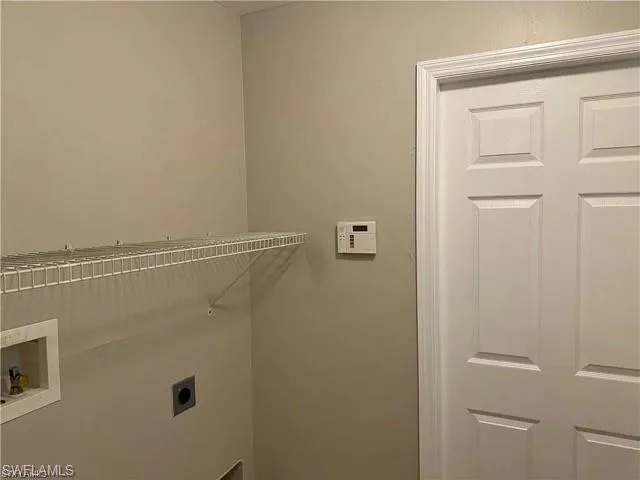 Washroom with hookup for an electric dryer and hookup for a washing machine