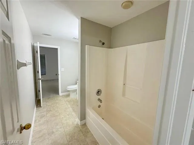 Full bathroom featuring bathing tub / shower combination and tile patterned flooring