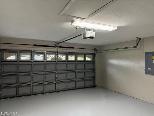 Garage with a garage door opener and electric panel