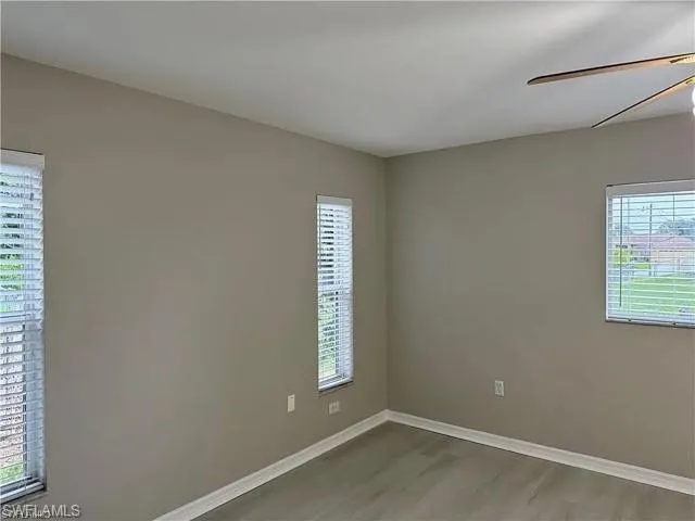 Unfurnished room with plenty of natural light and wood finished floors