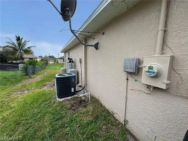 View of side of home with stucco siding and a central AC unit