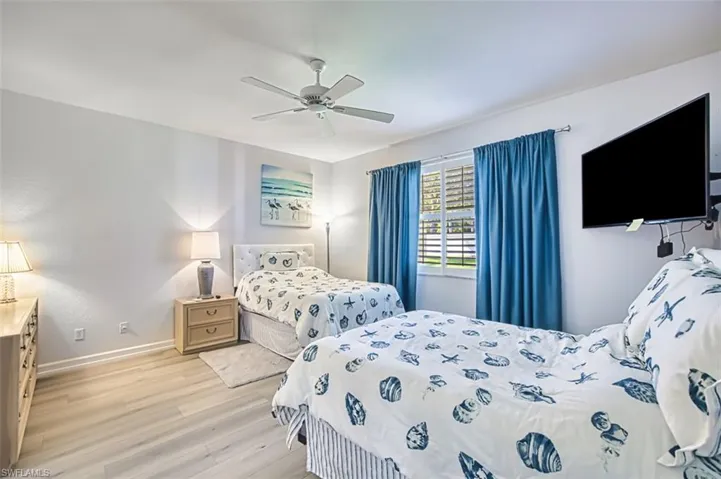 Bedroom with light wood-style floors and ceiling fan