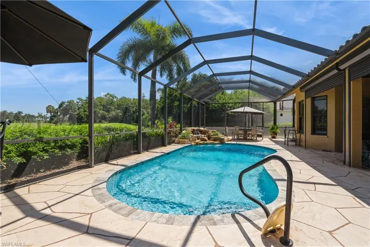 View of swimming pool with a lanai and a patio area