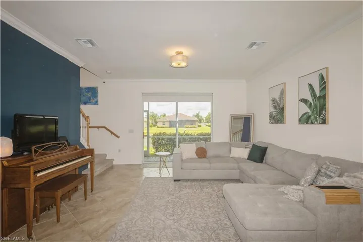Tiled living room featuring ornamental molding