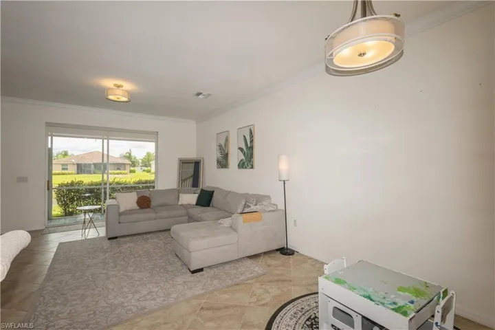 Tiled living room featuring ornamental molding