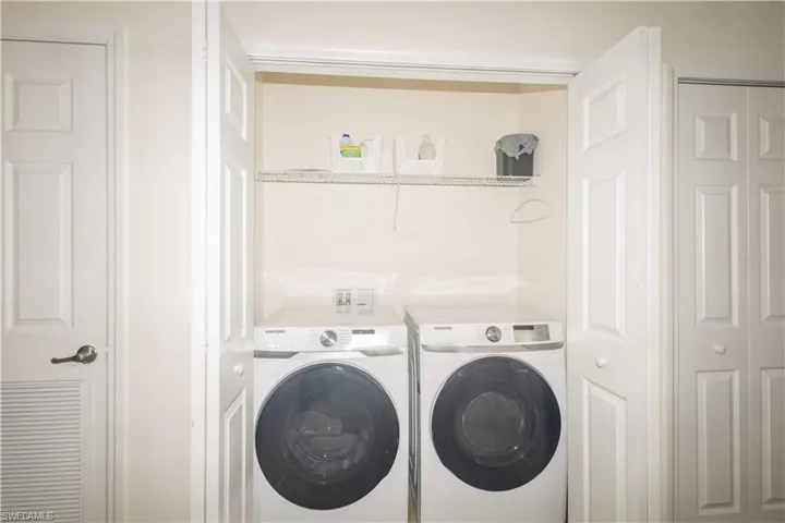 Washroom featuring washer and clothes dryer