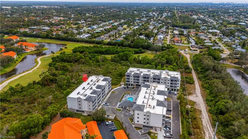 Birds eye view of property with a water view
