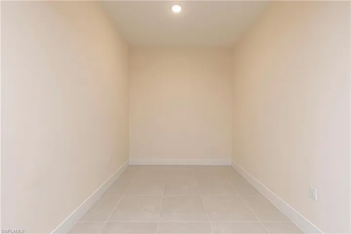 Unfurnished room with light tile patterned floors