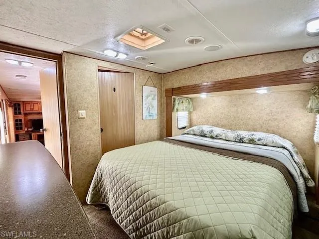 Bedroom with a textured ceiling