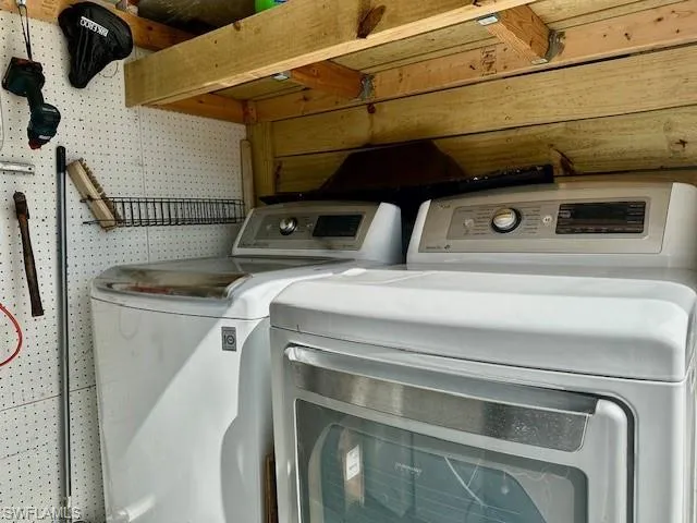 Laundry room with washing machine and clothes dryer