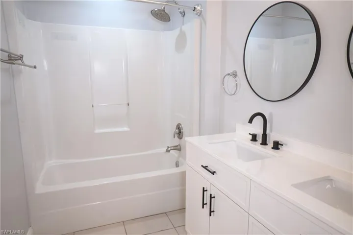 Master bath with tub & shower, double-sink vanity.