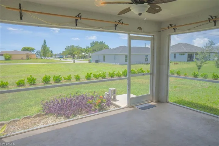 Kitchen featuring granite countertops, stainless steel appliances, white cabinetry, light tile patterned floors.