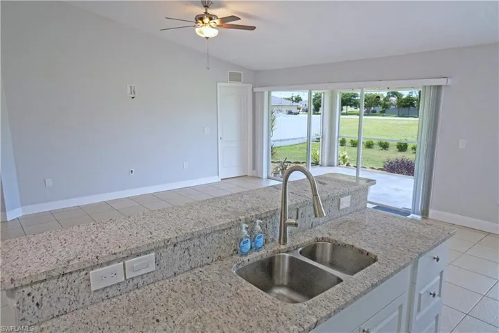 Screened in patio with ceiling fan.