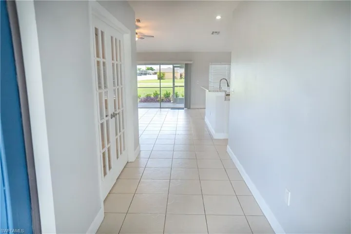 Entry Corridor with light tile patterned flooring and recessed lighting