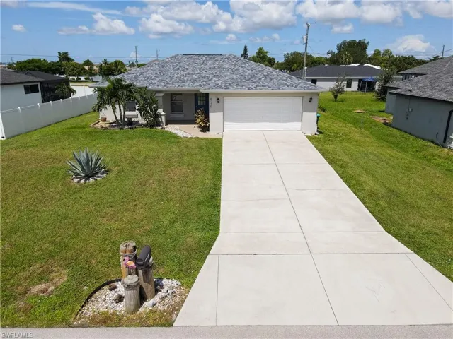 Ranch-style home featuring concrete driveway, a garage, and stucco siding