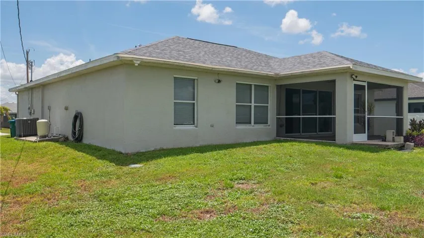 View of side of home featuring concrete pad, well system for irrigation