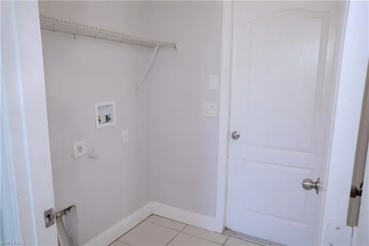 View of the kitchen and entryway, vaulted ceilings.