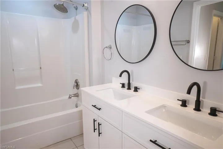 Master bath with tub & shower, double-sink vanity.