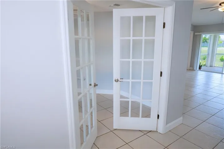 Laundry room featuring washer hookup, light tile patterned flooring, and hookup for an electric dryer.