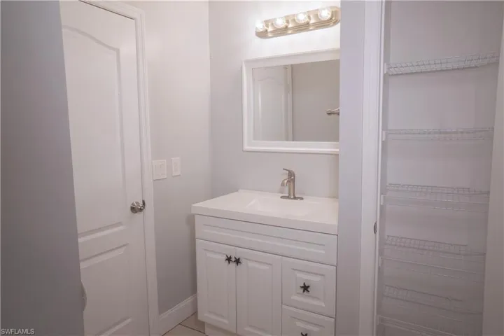 Jack and Jill bathroom featuring linen closet and shower / bathtub combination