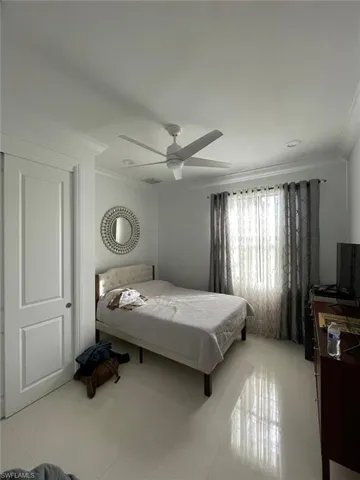 Bedroom with recessed lighting, light tile patterned flooring, ornamental molding, and a ceiling fan