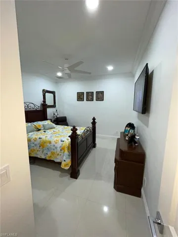 Bedroom featuring recessed lighting, a ceiling fan, light tile patterned floors, and crown molding