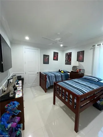 Ensuite bathroom with vanity, a shower stall, and light tile patterned floors