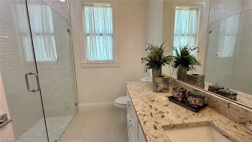 Foyer featuring french doors and light tile patterned flooring