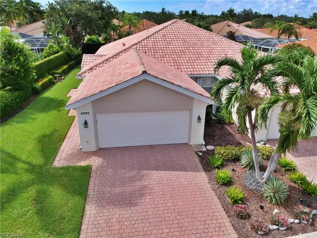 Mediterranean / spanish-style house featuring a garage and a front yard