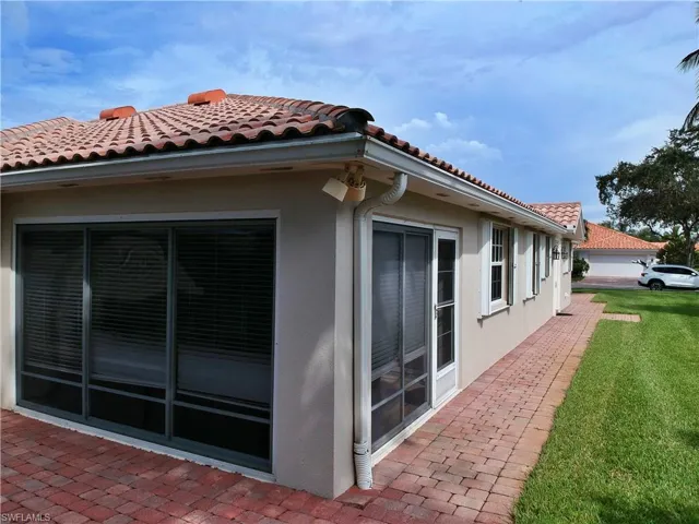 View of side of property featuring a lawn