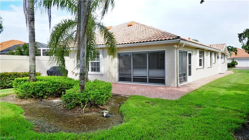 Back of property featuring a yard
