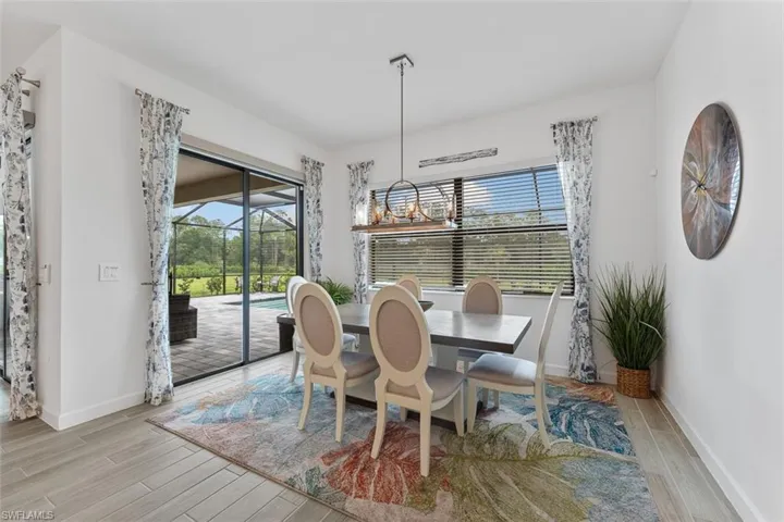 Dining area featuring baseboards, a healthy amount of sunlight, and light wood-type flooring