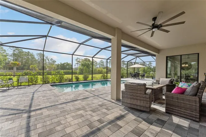 Outdoor pool with glass enclosure, outdoor lounge area, a patio area, ceiling fan, and outdoor dining area