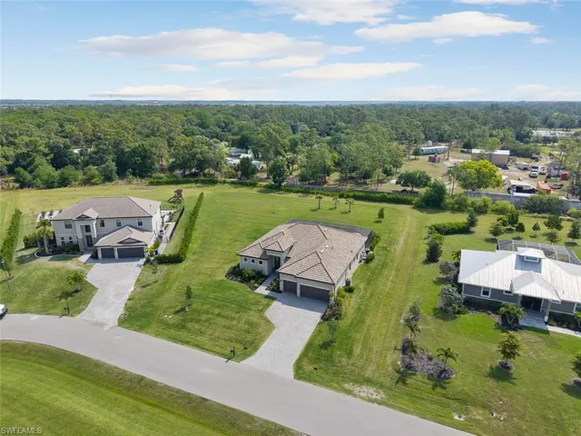 Birds eye view of property with a view of trees
