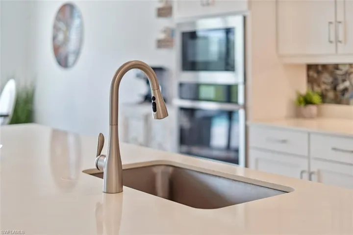 Details featuring white cabinets and light countertops