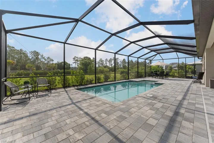 Outdoor pool with a lanai and a patio